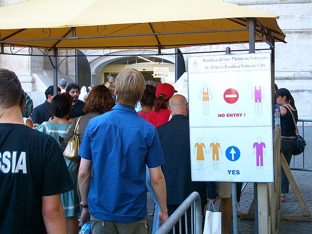 Vatican tourists queuing and signboard showing dress code